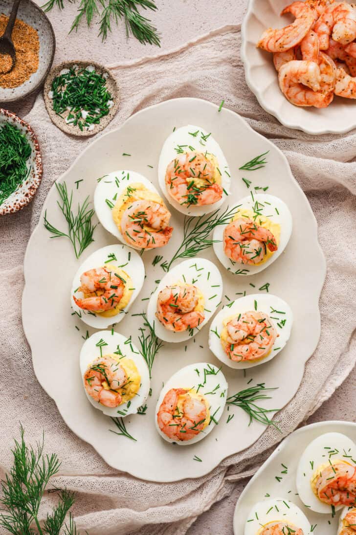 A light scalloped platter topped with shrimp deviled eggs.