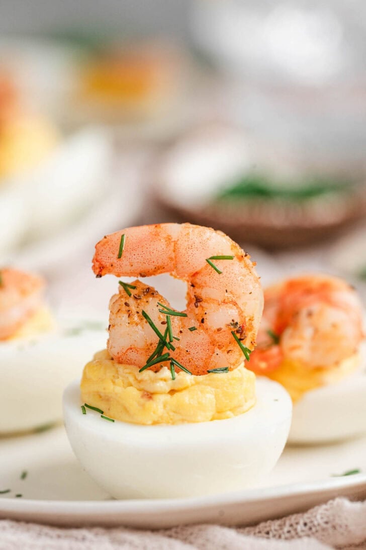 Deviled eggs with shrimp on top.