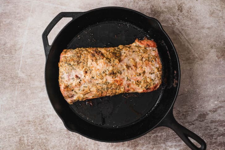 A roasted pork loin recipe in a cast iron skillet.