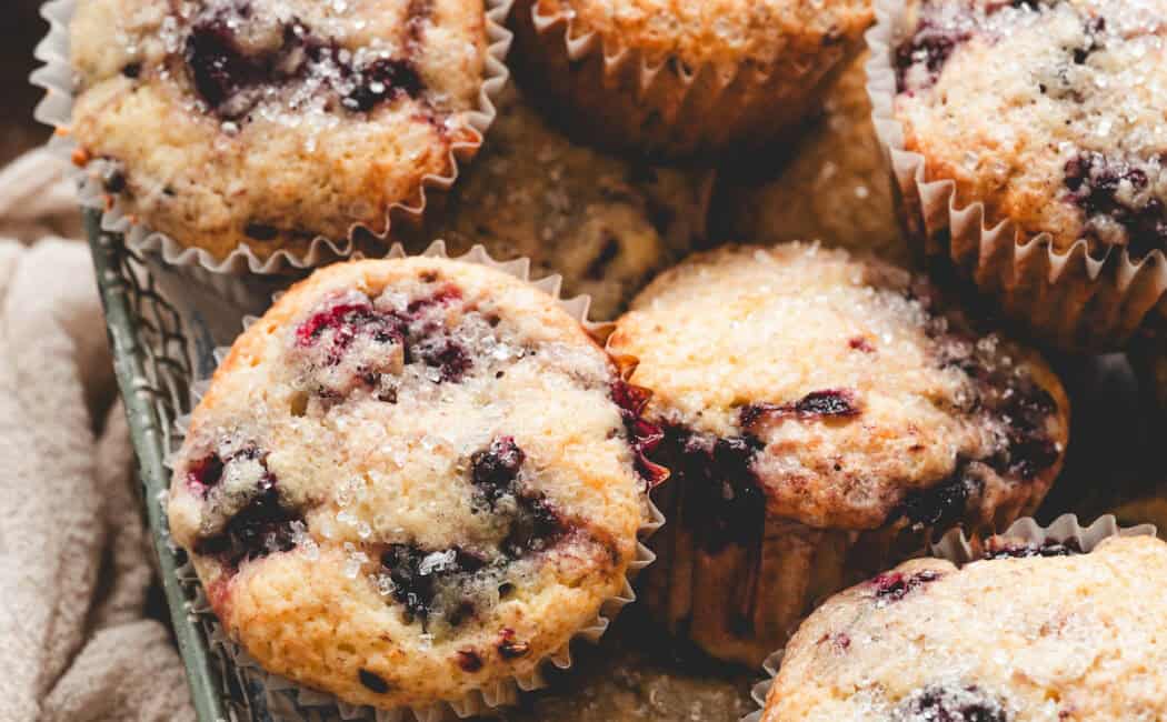A basket filled with blackberry muffins.