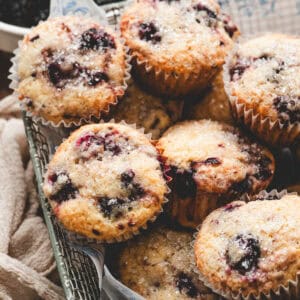A basket filled with blackberry muffins.