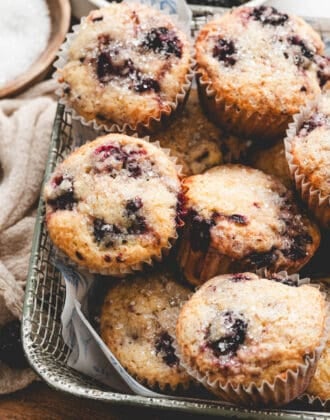 A basket filled with blackberry muffins.