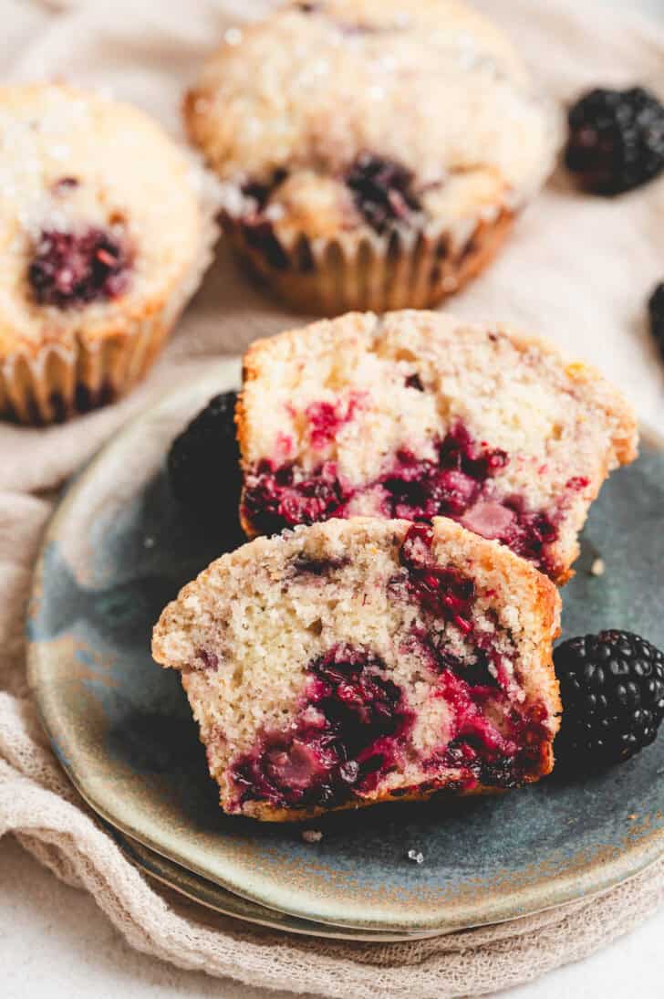 A blackberry muffin recipe, broke open on a plate.