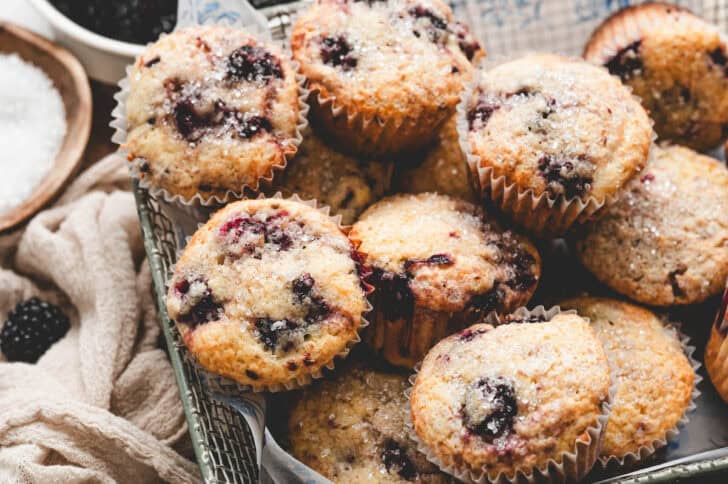 A basket filled with blackberry muffins from scratch.