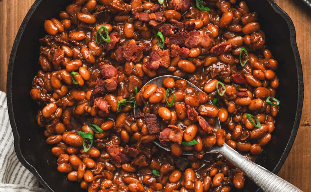 A skillet filled with Dr. Pepper baked beans.