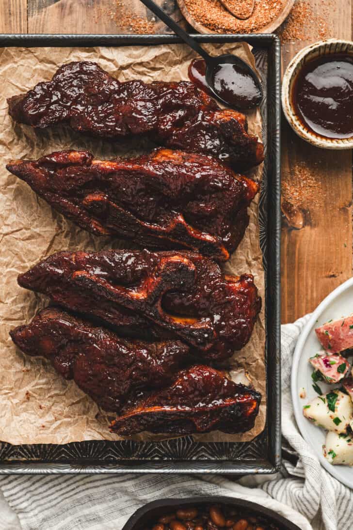 Country style ribs on a baking pan.
