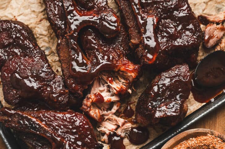 Closeup of country pork ribs being pulled apart.