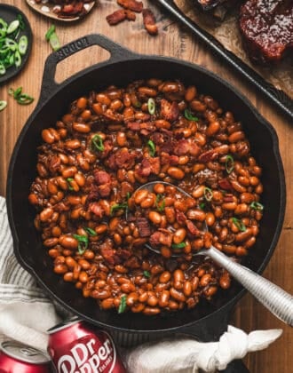 A cast iron skillet filled with Dr. Pepper baked beans