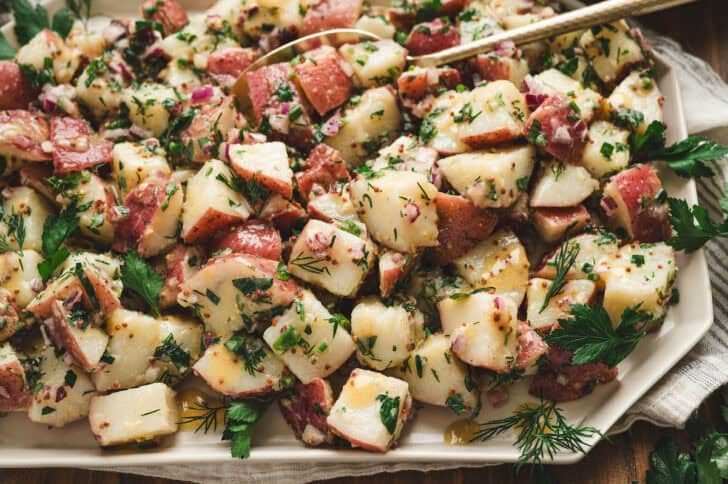 Lemon potato salad on a white platter.