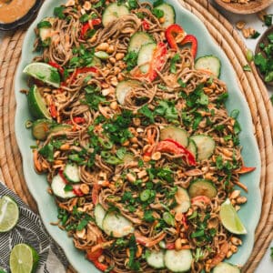 Asian noodle salad on a large teal platter.