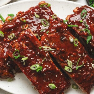 Asian spare ribs on a white platter.