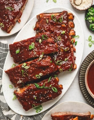 A large white platter filled with an Asian pork ribs recipe.