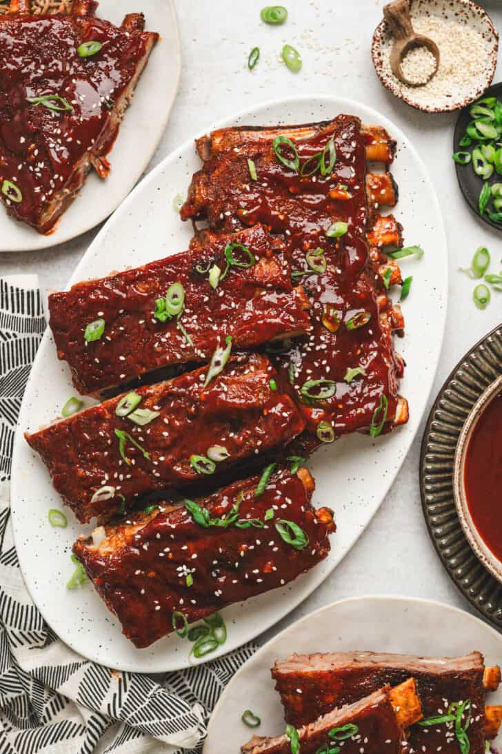 A large white platter filled with an Asian pork ribs recipe.