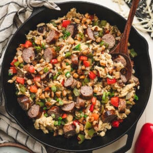 A cast iron skillet filled with a brat breakfast scramble.