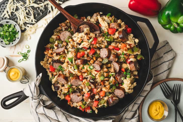 A sausage and egg scramble made with breakfast brats in a cast iron skillet.