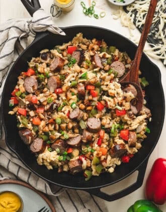 A cast iron skillet filled with a brat breakfast scramble.