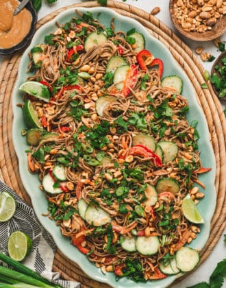 Asian noodle salad on a large teal platter.