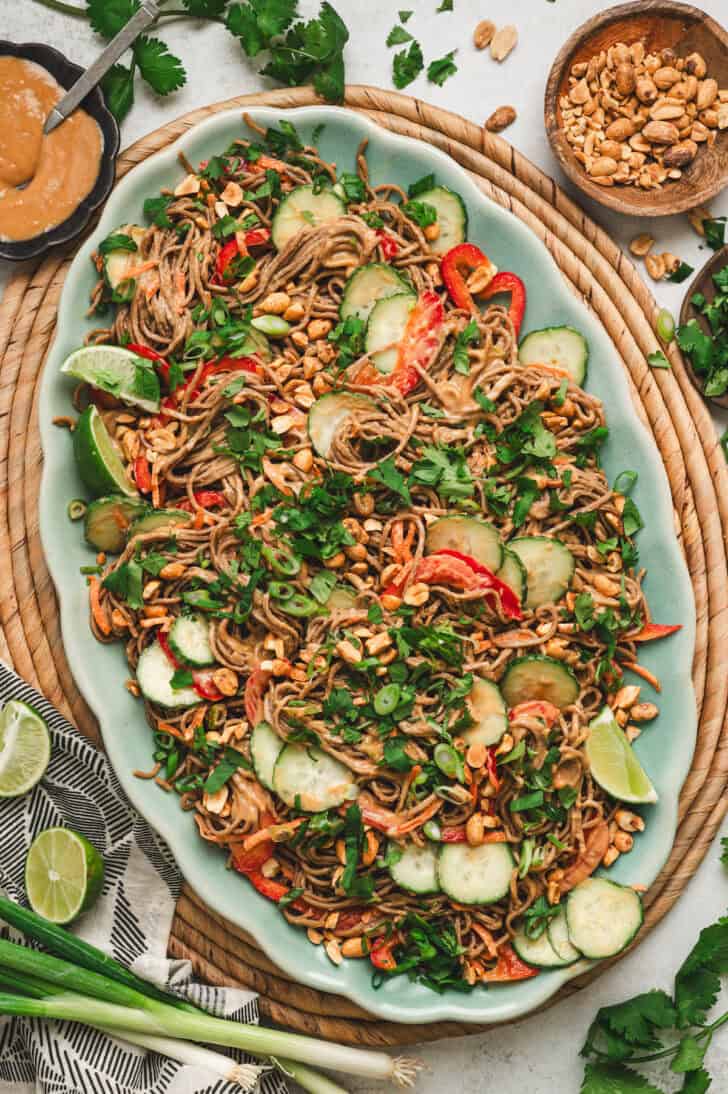 Asian noodle salad on a large teal platter.
