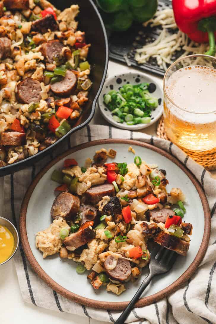 A plate filled with a brats for breakfast dish.