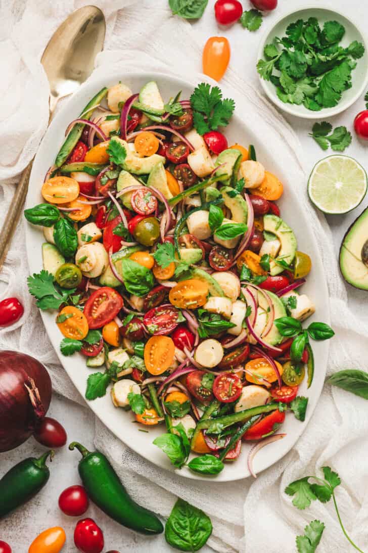Palm hearts recipe served as a fresh salad with avocado, tomatoes, red onion, herbs and citrus dressing.