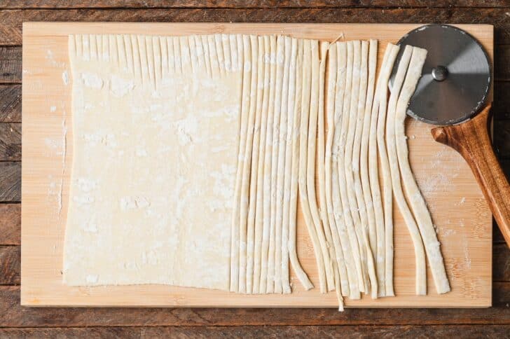 Puff pastry sheet sliced into thin strips with a pizza cutter to wrap puff pastry pigs in a blanket mummies