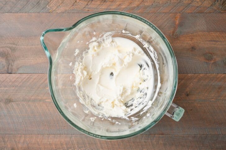 Cream cheese beaten smooth in a glass mixing bowl